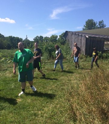 Adults building skills through farm activities at AACORN