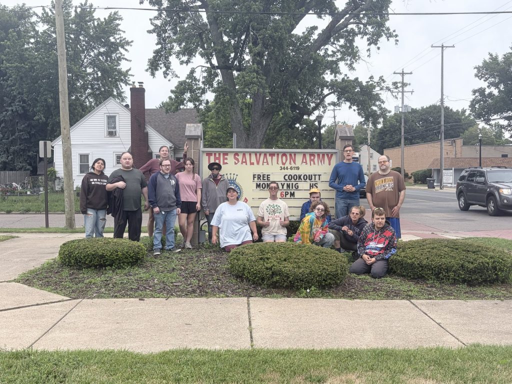 AACORN participants and staff gathered outside The Salvation Army during a community volunteer outing.