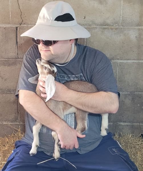 Participant holding baby goat.