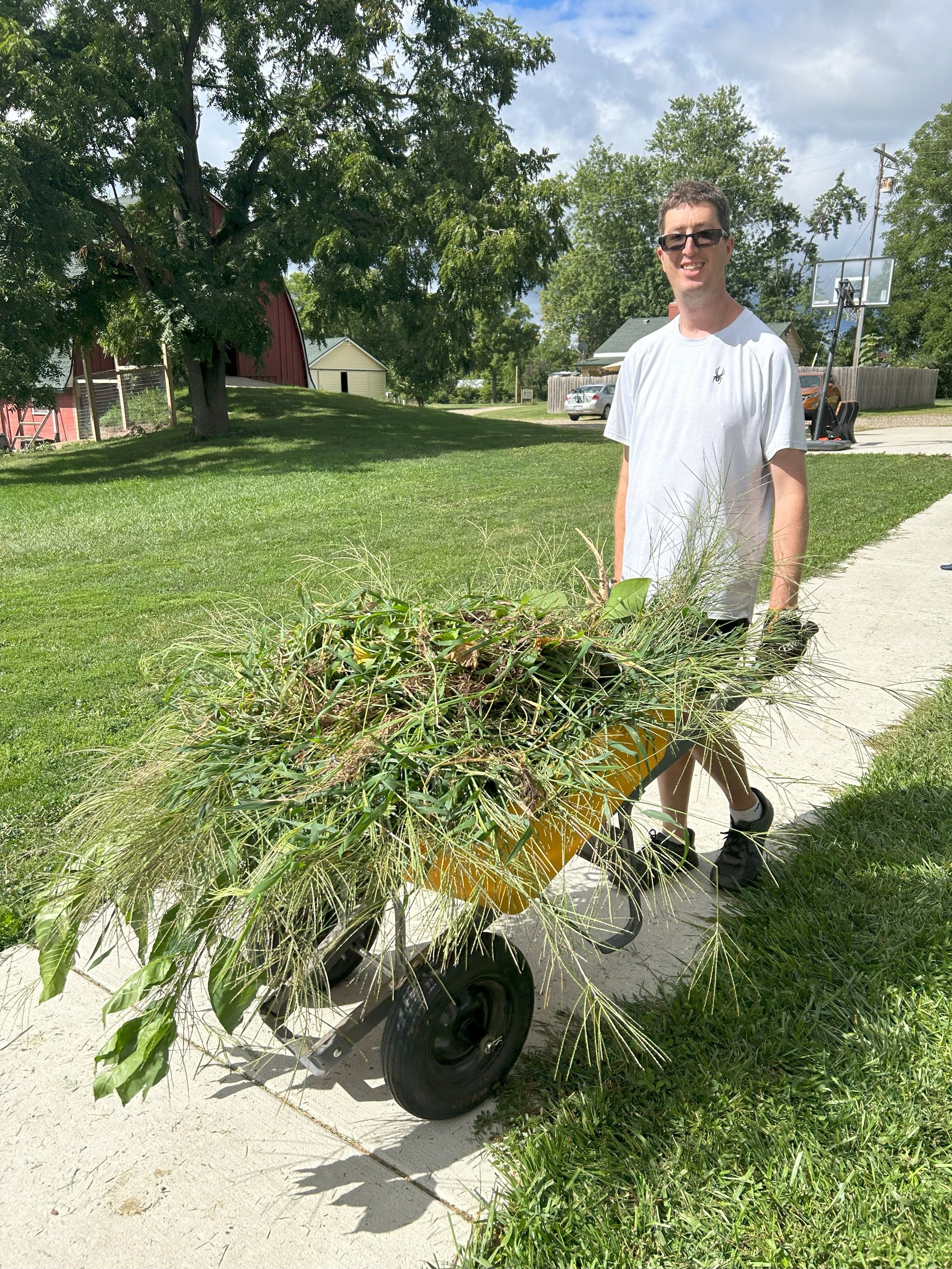 Participant with wheelbarrow full of yard clippings.